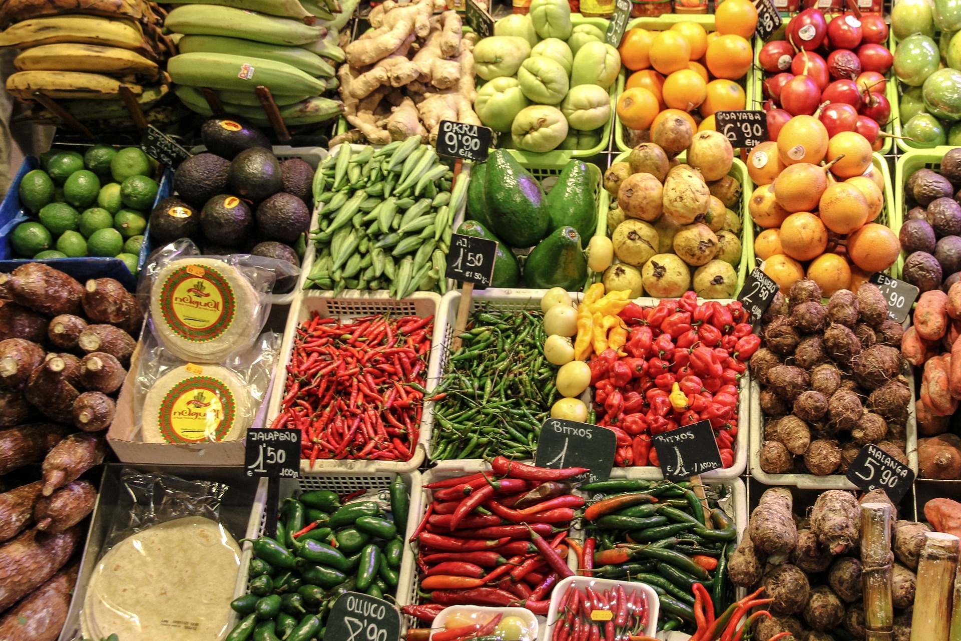 Trays of fruit and vegetables are arranged together